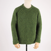 Green knitted sweater on a mannequin against a white background