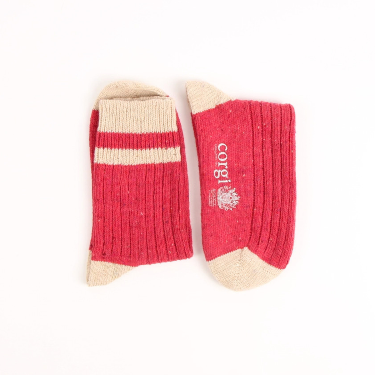 A pair of pink and beige crew socks laid flat on a white background, with one sock showing the striped cuff and the other showing the toe and the brand name 'corgi'.
