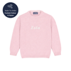 Pink sweater with 'Isla' kniited on it, brand 'corgi' visible, on a white background.