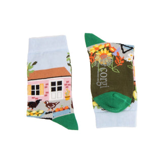 A pair of socks with a cottage-themed design on a white background
