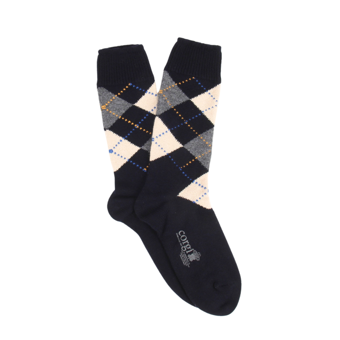 Navy argyle patterned sock on a white background