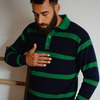 Man wearing a navy and green striped sweater against a neutral background