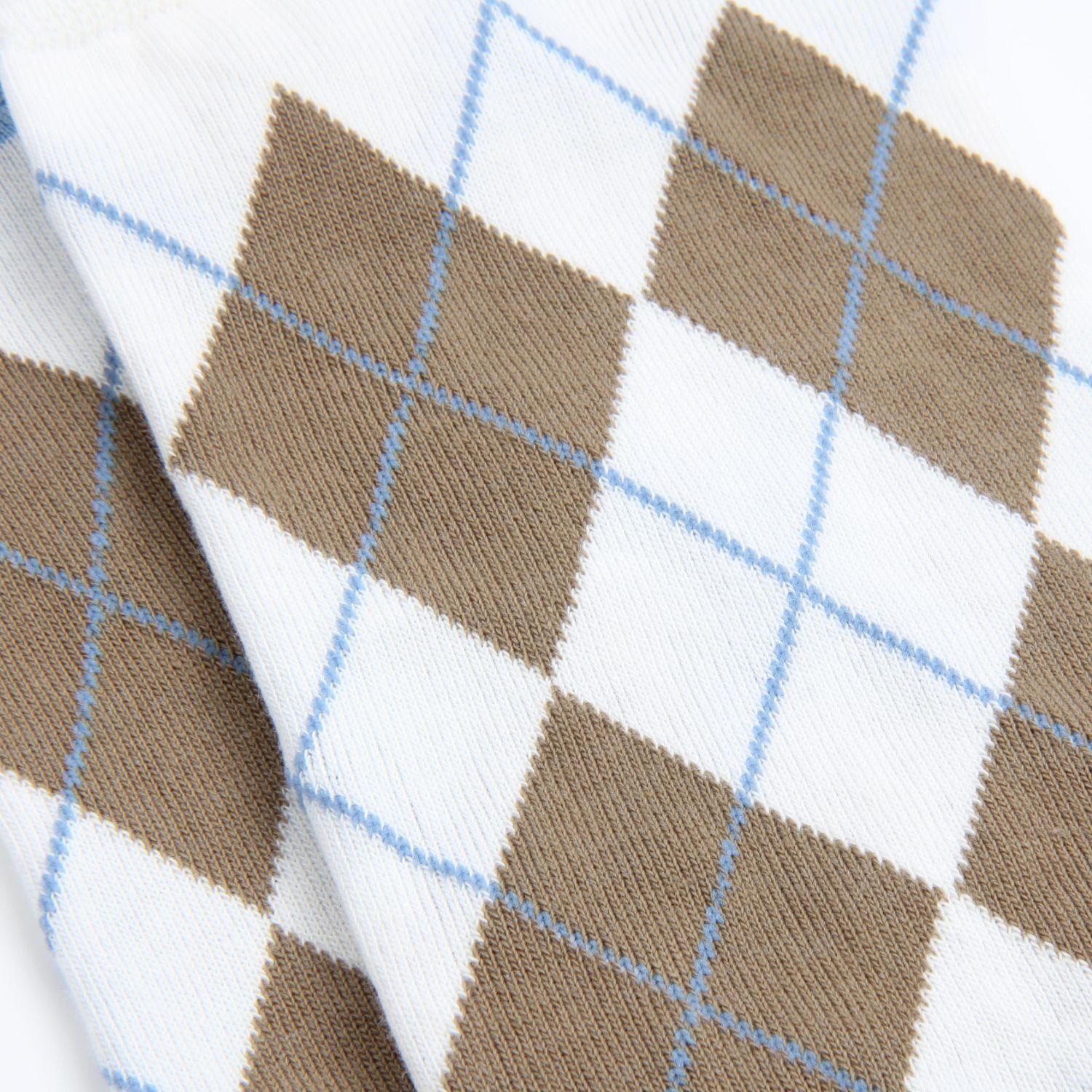 Close-up of a fabric with brown and white argyle pattern