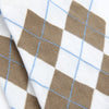 Close-up of a fabric with brown and white argyle pattern