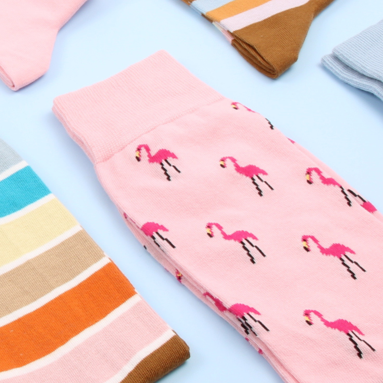 Pink socks with flamingo pattern on a light blue background