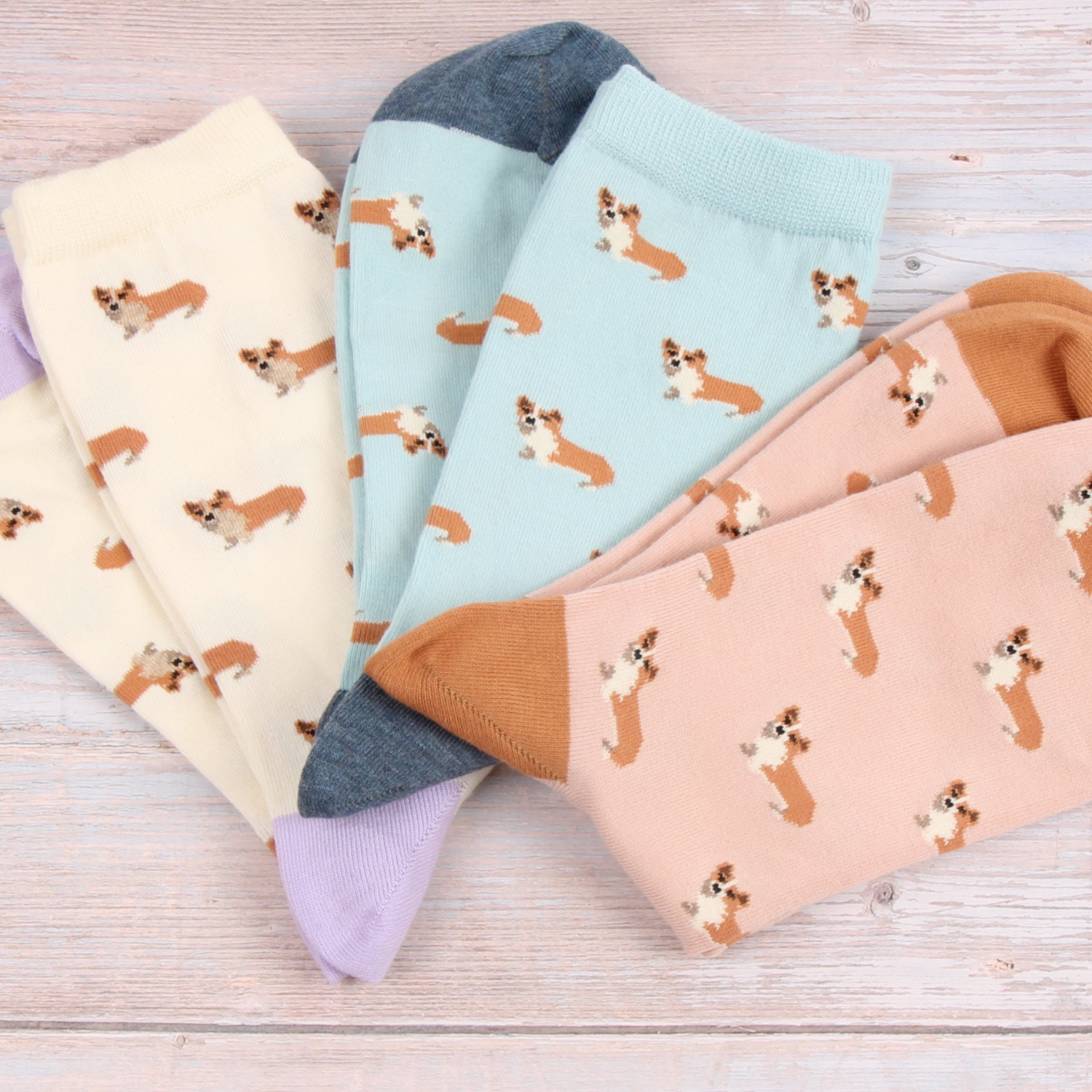 Set of colorful socks with dog pattern on a wooden surface
