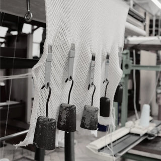 Textile production process with fabric and machinery in a factory setting