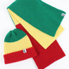 Colorful knit hat with green, yellow, and red stripes on a white background