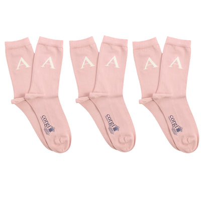 Set of three pink socks with white lettering on a white background
