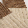 Close-up of a textured fabric with brown and beige pattern