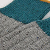 Close-up of a sock with grey and teal accent