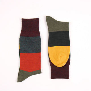 Two multicolored socks on a white background