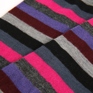 Close-up of multicolored striped fabric with pink, purple, gray, and black.