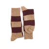 Pair of striped socks with brown and beige pattern on a white background