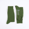 Green socks with 'corgi' branding on a white background