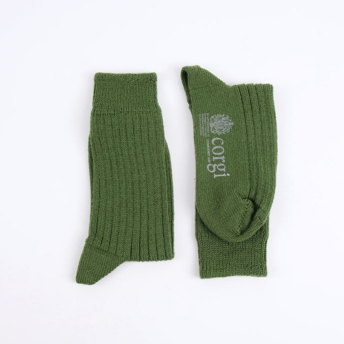 Green socks with 'corgi' branding on a white background