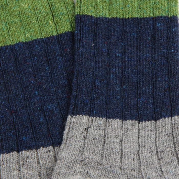 Close-up of multicoloured fabric with green, blue, and grey stripes.