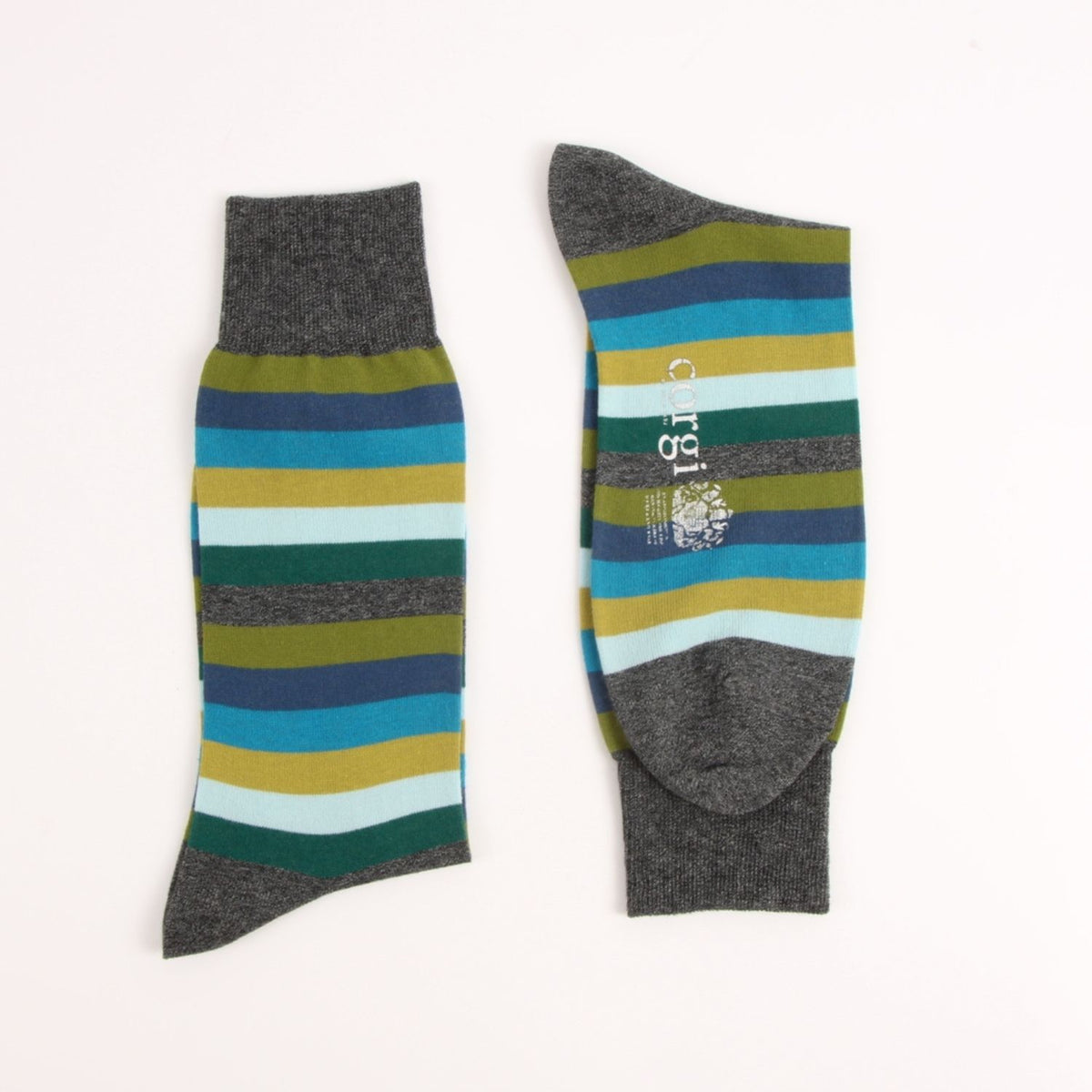 Close-up of a striped knit fabric with diagonal bands of blue, yellow, white, dark green, olive green, and heather gray.