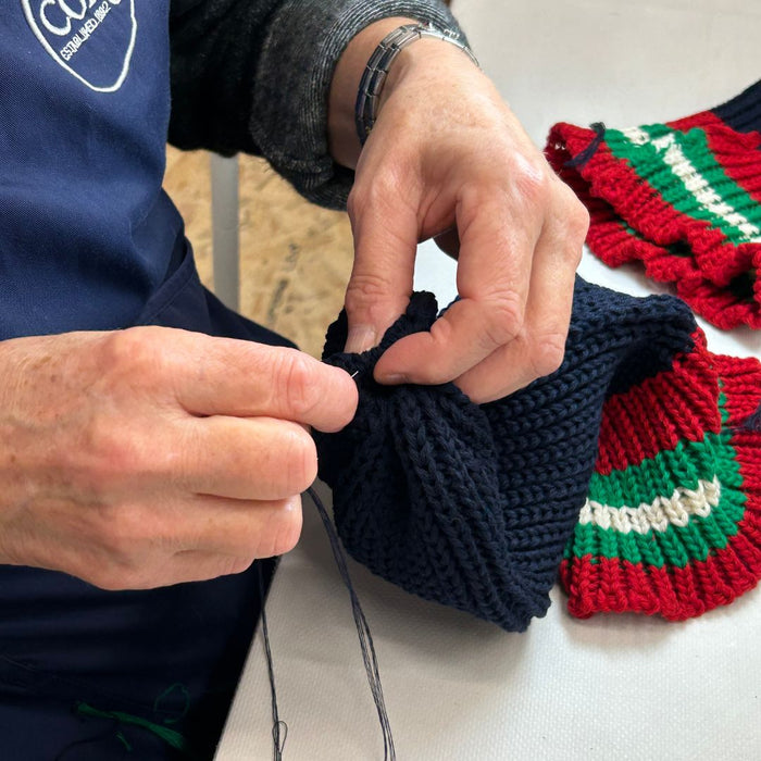 Corgi staff sewing the beanie hats in the factory.