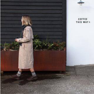 girl walking with a coffee wearing beige fair isle wool socks 