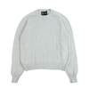 Light green sweater with a brand label on a white background