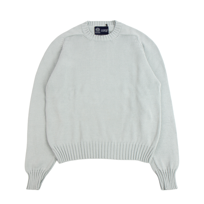 Light green sweater with a brand label on a white background