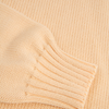Close-up of a yellow knitted fabric with a ribbed texture.