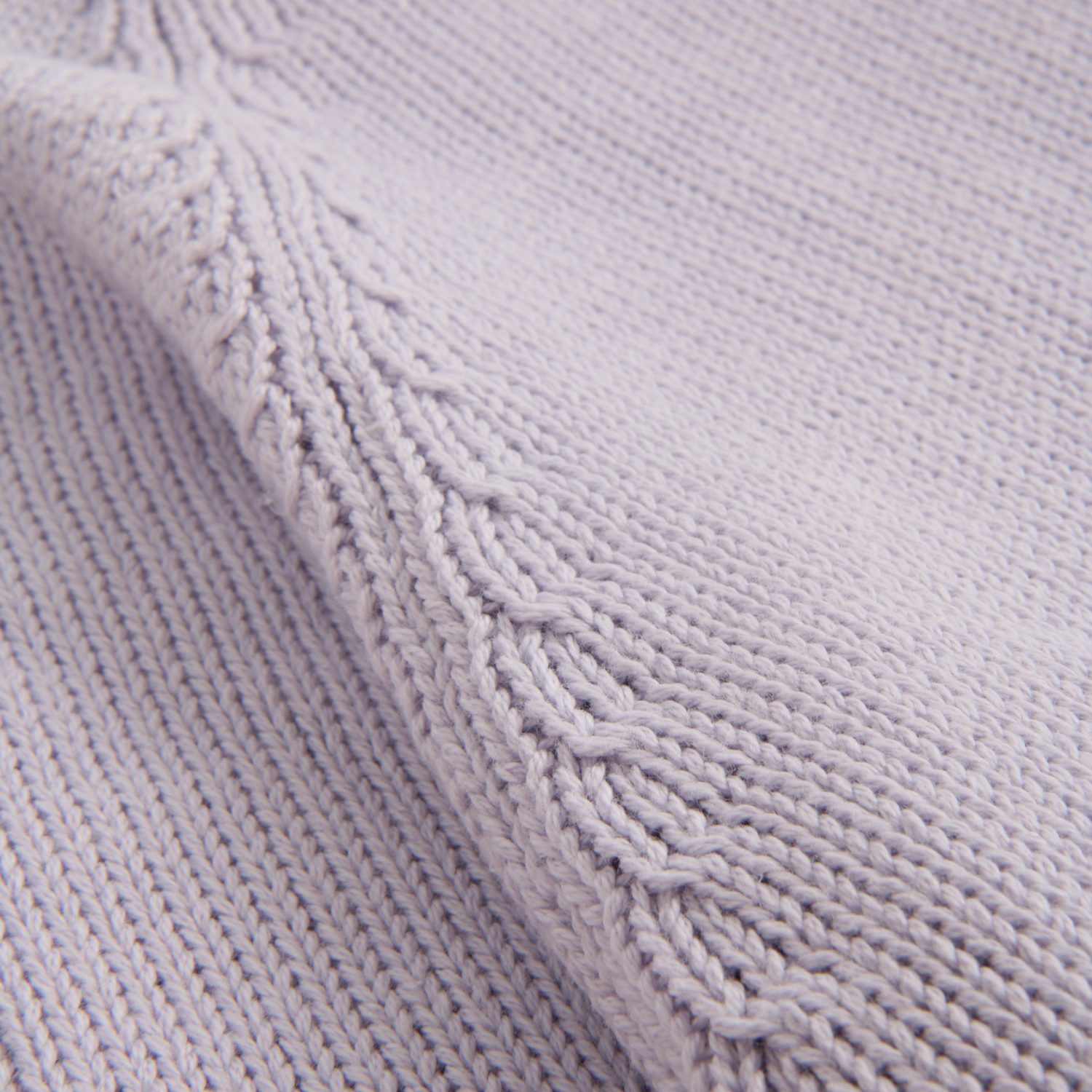Close-up of a textured purple fabric with knit pattern