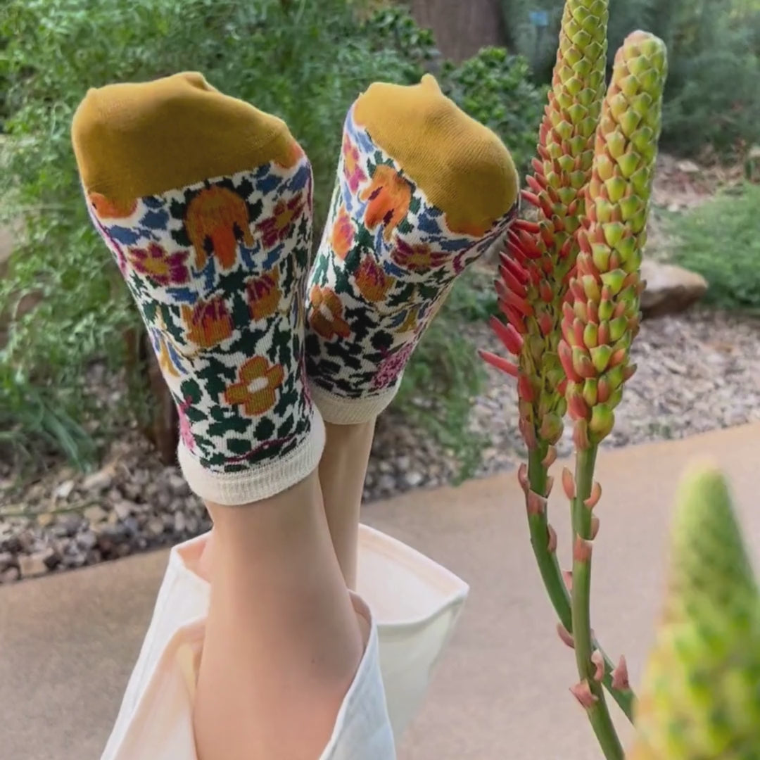 video of a person wearing floral trainer socks