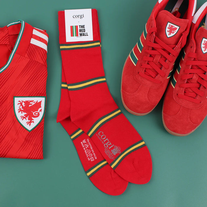 Red sports jersey, socks, and shoes with a visible brand logo on a green background