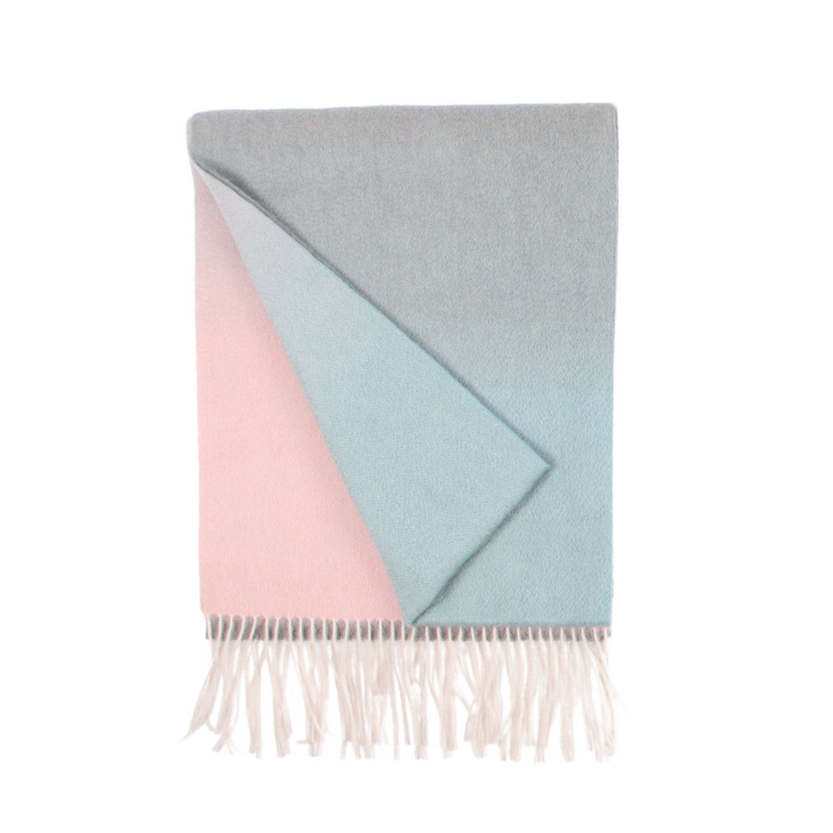 A woven cashmere scarf in ombre colour with a geometric triangle shape on a white background, featuring a fringe at the bottom.