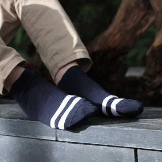 man wearing stripe toe cotton trainer socks in navy and white