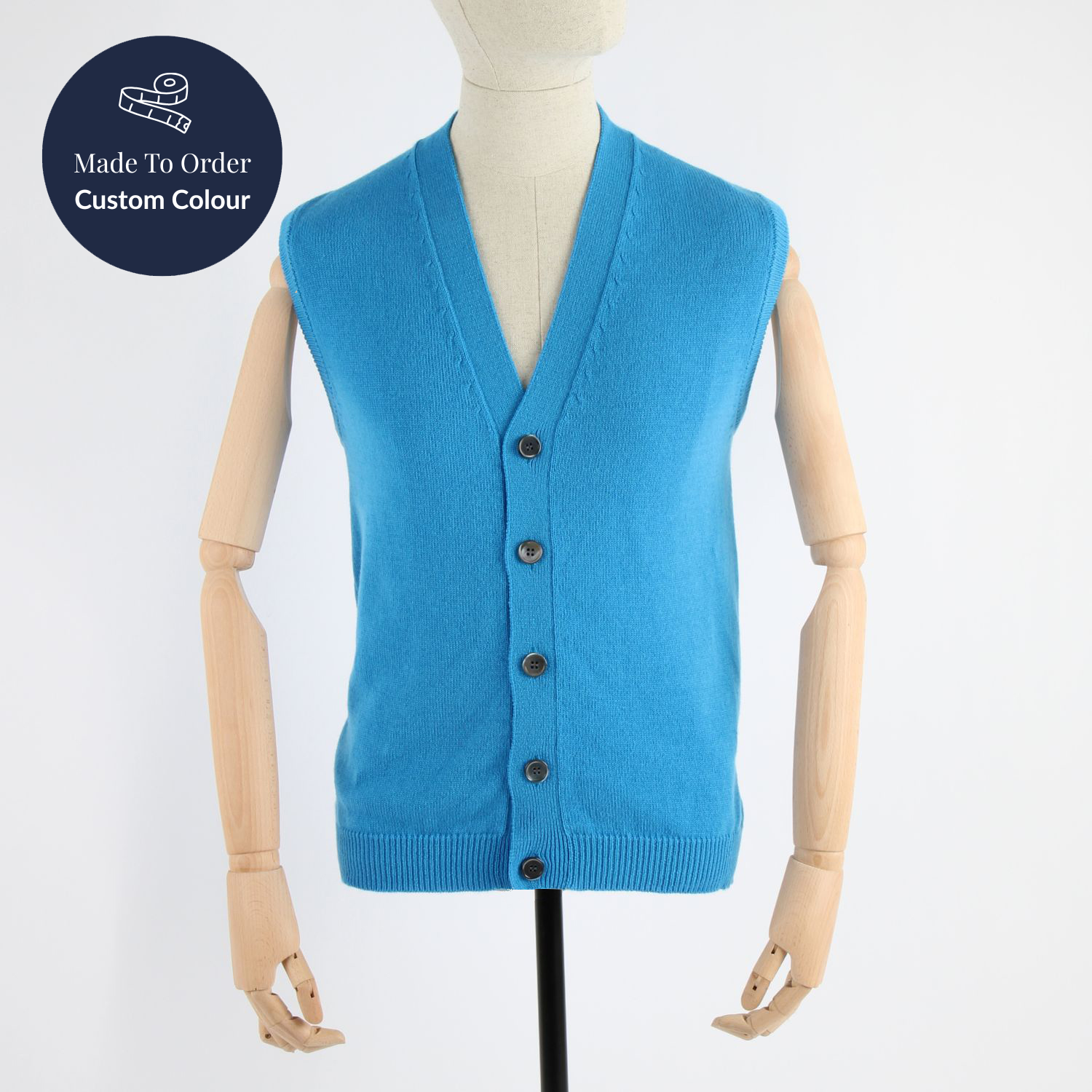 Blue cardigan vest on a mannequin with 'Made to Order Custom Colour' label.