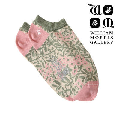 Pair of socks with floral pattern on a white background, featuring the William Morris Gallery logo.