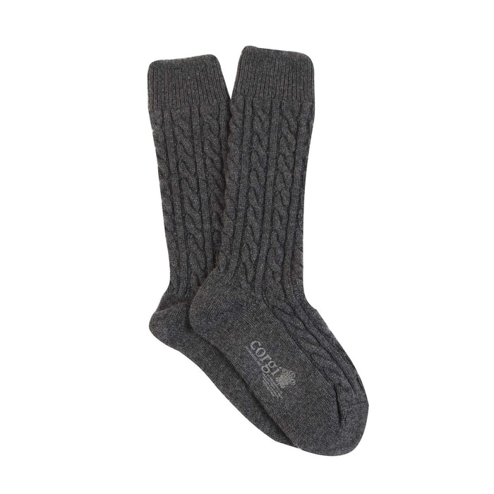 A pair of grey cashmere socks with a cable knit pattern, displayed against a white background.