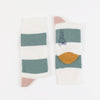 A pair of women's cashmere and cotton colour block socks with stripes in green and pink shades, and a gold toe.